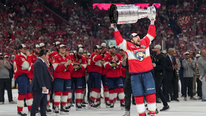 Jun 17, 2025; Sunrise, Florida, USA; Florida Panthers center Sam Reinhart (13) hoists the Stanley Cup after winning game six of the 2025 Stanley Cup Final against the Edmonton Oilers at Amerant Bank Arena. Mandatory Credit: Jim Rassol-Imagn Images