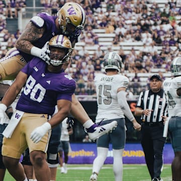 Jacob Bandes  jumps on Elinneus Davis to celebrate Davis' first sack.