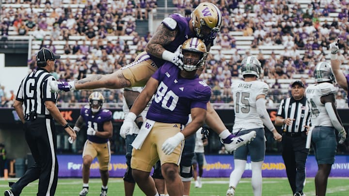 Jacob Bandes  jumps on Elinneus Davis to celebrate Davis' first sack.