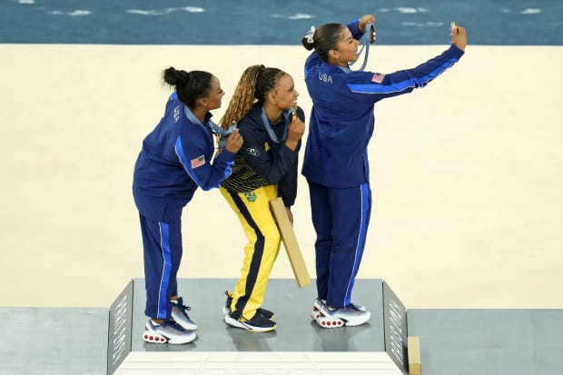 Simone Biles poses for a picture on the medal stand.