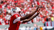 Sep 6, 2025; Raleigh, North Carolina, USA; North Carolina State Wolfpack quarterback CJ Bailey (11) celebrates a touchdown during the second half of the game against Virginia Cavaliers at Carter-Finley Stadium. Mandatory Credit: Jaylynn Nash-Imagn Images