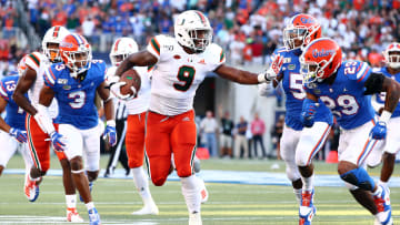 Aug 24, 2019; Orlando, FL, USA; Miami Hurricanes tight end Brevin Jordan (9) runs the ball against Florida Gators defensive back Jeawon Taylor (29) during the first quarter at Camping World Stadium. Mandatory Credit: Kim Klement-USA TODAY Sports