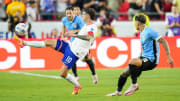 United States forward Christian Pulisic controls the ball against Uruguay defender Mathías Olivera during the first half of a Copa America match at Arrowhead Stadium.