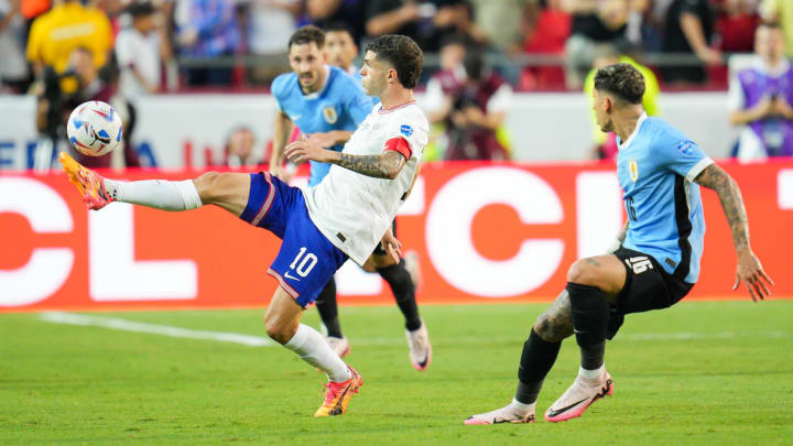 United States forward Christian Pulisic controls the ball against Uruguay defender Mathías Olivera during the first half of a Copa America match at Arrowhead Stadium.