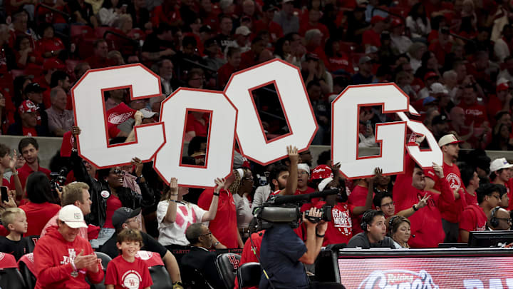 Houston Cougars student section holding up 'COOGS' letters at Fertitta Center.