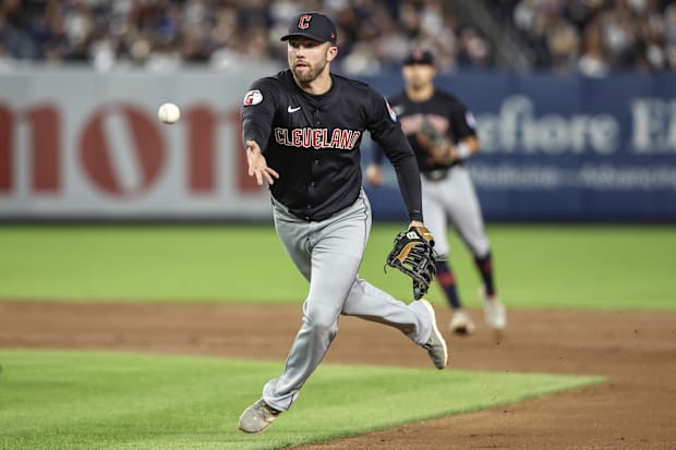 David Fry flips a ball to first base 