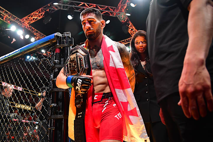 Ilia Topuria celebrates his championship victory against Alexander Volkanovski during UFC 298.