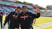 Oct 25, 2025; Chapel Hill, North Carolina, USA; Virginia Cavaliers head coach Tony Elliott runs off the field after defeating the North Carolina Tar Heels in overtime at Kenan Stadium. Mandatory Credit: Bob Donnan-Imagn Images