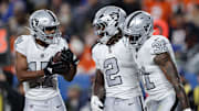 Nov 6, 2025; Denver, Colorado, USA; Las Vegas Raiders wide receiver Tyler Lockett (17) reacts with running back Ashton Jeanty (2) and running back Raheem Mostert (31) during the first half at Empower Field at Mile High. Mandatory Credit: Isaiah J. Downing-Imagn Images