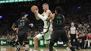 Feb 9, 2024; Boston, Massachusetts, USA; Washington Wizards guard Jordan Poole (13) defends Boston Celtics center Kristaps Porzingis (8) during the second half at TD Garden. Mandatory Credit: Bob DeChiara-Imagn Images