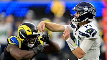 Nov 16, 2025; Inglewood, California, USA;  Seattle Seahawks quarterback Sam Darnold (14) is pressured by Los Angeles Rams linebacker Byron Young (0) at SoFi Stadium. Mandatory Credit: Jayne Kamin-Oncea-Imagn Images