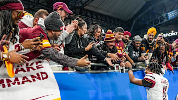 Washington Commanders quarterback Jayden Daniels shakes hands and high-fives fans after defeating the Detroit Lions 45-31 in the NFC divisional round playoff game.