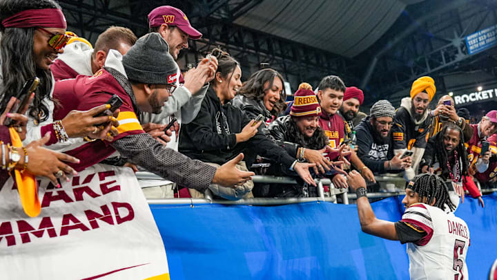 Washington Commanders quarterback Jayden Daniels shakes hands and high-fives fans after defeating the Detroit Lions 45-31 in the NFC divisional round playoff game. Washington Commanders quarterback Jayden Daniels shakes hands and high-fives fans after defeating the Detroit Lions 45-31 in the NFC divisional round playoff game.