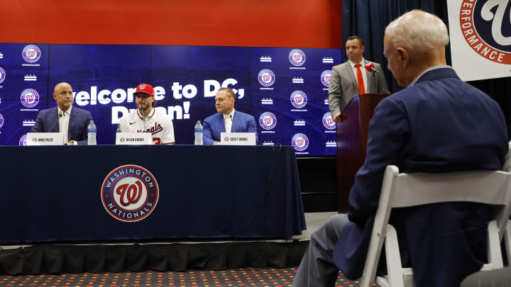 Jul 22, 2023; Washington, District of Columbia, USA; Washington Nationals principal owner Mark Lerner (R) listens in the audience as Nationals' first round draft pick outfielder Dylan Crews (M) speaks at an introductory press conference prior to the Nationals' game against the San Francisco Giants at Nationals Park.