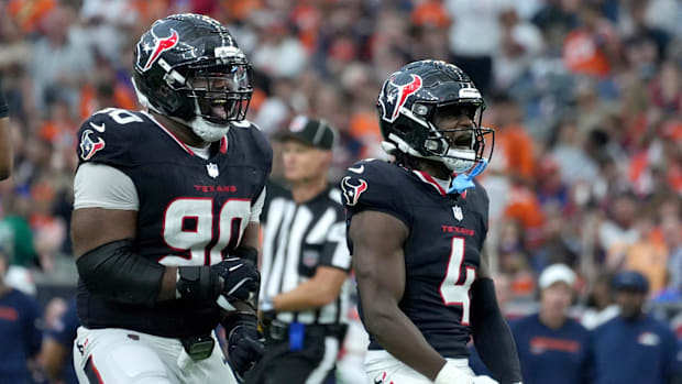 Nov 2, 2025; Houston, Texas, USA; Houston Texans defensive tackle Sheldon Rankins (90) and cornerback Kamari Lassiter (4) cel