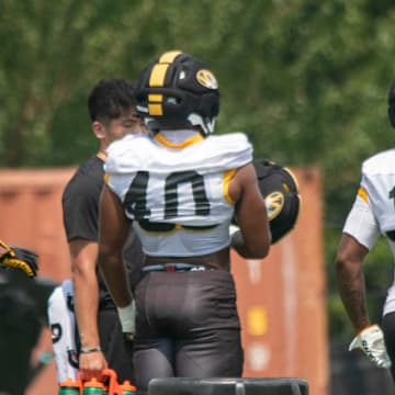 Aug 6, 2025; Columbia, MO, USA; Missouri Tigers linebackers Josiah Trotter (40) and Jeremiah Beasley (18) get ready for a defensive drill during a fall camp practice at Mizzou Athletic Training Complex.