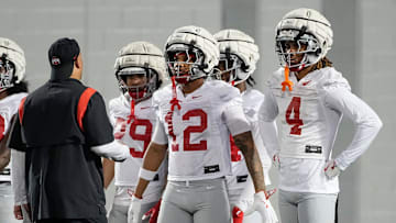 Ohio State Buckeyes cornerbacks Devin Sanchez (4) Bryce West (12) listen to coach Tim Walton during spring football practice at the Woody Hayes Athletic Center in Columbus on March 19, 2025.