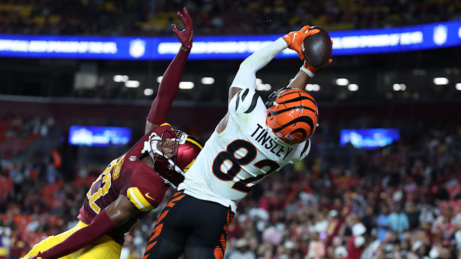 Aug 18, 2025; Landover, Maryland, USA; Cincinnati Bengals wide receiver Mitchell Tinsley (82) catches a touchdown pass over Washington Commanders cornerback Car'lin Vigers (22) during the first half at Northwest Stadium. Mandatory Credit: Amber Searls-Imagn Images | Amber Searls-Imagn Images