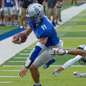 Holmdel’ quarterback Jack Cannon drives for the end zone and scores. Holmdel Football defeats Long Branch 38-32 in Holmdel NJ on August 30, 2024.