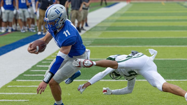 Holmdel’ quarterback Jack Cannon drives for the end zone and scores. Holmdel Football defeats Long Branch 38-32 in Holmdel NJ on August 30, 2024.