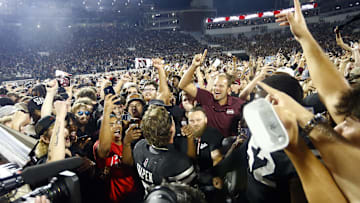 Sep 6, 2025; Starkville, Mississippi, USA; Mississippi State Bulldogs fans crowd around quarterback Blake Shapen (2) after defeating the Arizona State Sun Devilsat Davis Wade Stadium at Scott Field. Mandatory Credit: Petre Thomas-Imagn Images
