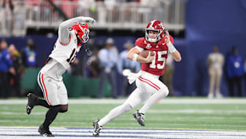 Dec 6, 2025; Atlanta, GA, USA; Alabama Crimson Tide quarterback Ty Simpson (15) rushes as Georgia Bulldogs linebacker Zayden Walker (10) defends during the fourth quarter during the 2025 SEC Championship game at Mercedes-Benz Stadium. Mandatory Credit: Brett Davis-Imagn Images