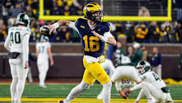 Michigan quarterback Davis Warren (16) warms up before the Michigan State game at Michigan Stadium in Ann Arbor on Saturday, Oct. 26, 2024.