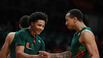 Feb 11, 2025; Coral Gables, Florida, USA; Miami Hurricanes guard Jalil Bethea (3) celebrates with guard Matthew Cleveland (0) after scoring against the Syracuse Orange during the second half at Watsco Center. Mandatory Credit: Sam Navarro-Imagn Images