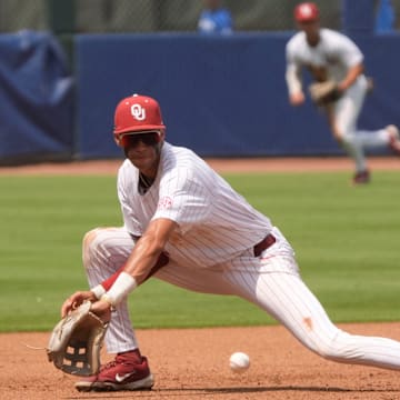 May 20, 2025; Hoover, AL, USA; Oklahoma third baseman Dawson Willis (5) fields and throws to second to start a double play during the game with Kentucky in the first round of the SEC Baseball Tournament at the Hoover Met.