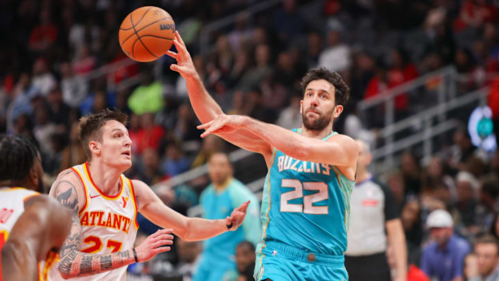 Mar 23, 2024; Atlanta, Georgia, USA; Charlotte Hornets guard Vasa Micic (22) passes the ball around Atlanta Hawks guard Vit Krejci (27) in the second half at State Farm Arena. Mandatory Credit: Brett Davis-USA TODAY Sports