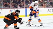 Apr 12, 2025; Philadelphia, Pennsylvania, USA; New York Islanders defenseman Alexander Romanov (28) passes the puck against the Philadelphia Flyers in the third period at Wells Fargo Center. Mandatory Credit: Kyle Ross-Imagn Images