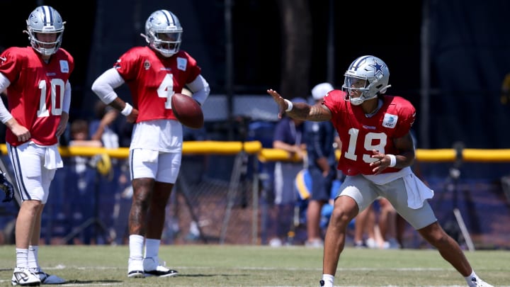 Jul 31, 2024; Oxnard, CA, USA; Dallas Cowboys quarterback Trey Lance (19) pitches in front of quarterback Cooper Rush (10) and quarterback Dak Prescott (4) during training camp at the River Ridge Playing Fields in Oxnard, California.  