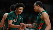 Feb 11, 2025; Coral Gables, Florida, USA; Miami Hurricanes guard Jalil Bethea (3) celebrates with guard Matthew Cleveland (0) after scoring against the Syracuse Orange during the second half at Watsco Center. Mandatory Credit: Sam Navarro-Imagn Images