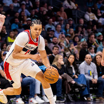 Mar 1, 2025; Charlotte, North Carolina, USA; Washington Wizards forward Kyshawn George (18) drives on Charlotte Hornets guard LaMelo Ball (1) during the fourth quarter at Spectrum Center. Mandatory Credit: Scott Kinser-Imagn Images