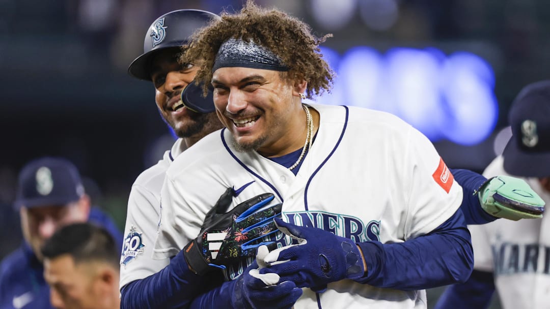 Apr 22, 2026; Seattle, Washington, USA; Seattle Mariners first baseman Josh Naylor (12, left) celebrates with center fielder Julio Rodríguez (44) after hitting a walk-off RBI-single against the Athletics during the ninth inning at T-Mobile Park. Mandatory Credit: Joe Nicholson-Imagn Images