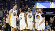 Oct 8, 2025; San Francisco, California, USA;  Golden State Warriors guard Taevion Kinsey (77) huddles with guard LJ Cryer (18), center Quinten Post (21), guard Will Richard (3), and guard Pat Spencer (61) during the fourth quarter against the Portland Trail Blazers at Chase Center. Mandatory Credit: John Hefti-Imagn Images