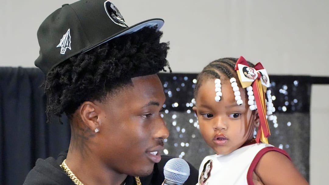 Friends and family celebrate after Booker High defensive end/wide receiver Chauncey Kennon announces he has selected Florida State University to commit to during a party Sunday afternoon, July 6, 2025 at the DeSoto Boys and Girls Club in Bradenton.