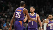 Mar 17, 2025; Phoenix, Arizona, USA; Phoenix Suns forward Kevin Durant (35) celebrates with guard Devin Booker (1) after scoring against the Toronto Raptors in the first half at Footprint Center. Mandatory Credit: Rick Scuteri-Imagn Images