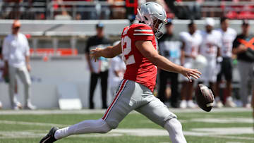 Aug 30, 2025; Columbus, Ohio, USA;Ohio State Buckeyes punter Joe McGuire (42) punts the ball against the Texas Longhorns in the first half at Ohio Stadium. Mandatory Credit: Joseph Maiorana-Imagn Images