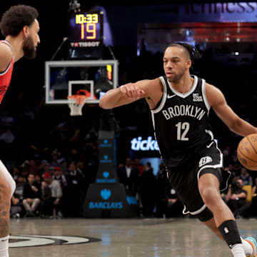 Mar 28, 2025; Brooklyn, New York, USA; Brooklyn Nets forward Tosan Evbuomwan (12) drives to the basket against Los Angeles Clippers guard Ben Simmons (25) during the fourth quarter at Barclays Center. Mandatory Credit: Brad Penner-Imagn Images