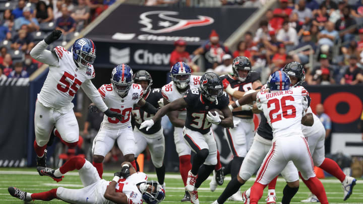 Aug 17, 2024; Houston, Texas, USA;  Houston Texans running back J.J. Taylor (38) rushes against the New York Giants in the third quarter at NRG Stadium.  