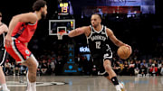 Mar 28, 2025; Brooklyn, New York, USA; Brooklyn Nets forward Tosan Evbuomwan (12) drives to the basket against Los Angeles Clippers guard Ben Simmons (25) during the fourth quarter at Barclays Center. Mandatory Credit: Brad Penner-Imagn Images 
