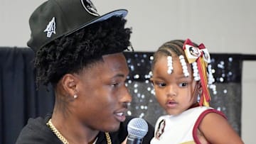Friends and family celebrate after Booker High defensive end/wide receiver Chauncey Kennon announces he has selected Florida State University to commit to during a party Sunday afternoon, July 6, 2025 at the DeSoto Boys and Girls Club in Bradenton.