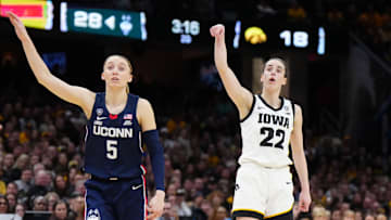 Apr 5, 2024; Cleveland, OH, USA; Iowa Hawkeyes guard Caitlin Clark (22) and Connecticut Huskies guard Paige Bueckers (5) react in the second quarter in the semifinals of the Final Four of the womens 2024 NCAA Tournament at Rocket Mortgage FieldHouse. Mandatory Credit: Kirby Lee-Imagn Images