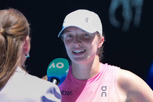 Iga Swiatek speaks in an on-court interview after a match.