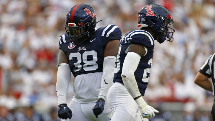 Aug 31, 2024; Oxford, Mississippi, USA; Mississippi Rebels defensive linemen JJ Pegues (38) and Mississippi Rebels wide receiver Drew Burnett (23) react after a tackle during the first quarter against the Furman Paladins at Vaught-Hemingway Stadium. Mandatory Credit: Petre Thomas-USA TODAY Sports