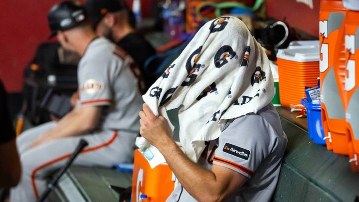 Phoenix, Arizona, USA; San Francisco Giants pitcher Landen Roupp reacts in the dugout after being pulled from the game in the third inning against the Arizona Diamondbacks at Chase Field. Mandatory Credit: Mark J. Rebilas-Imagn Images