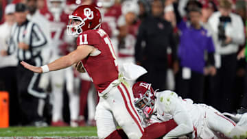 Alabama Crimson Tide defensive back Malachi Moore (13) brings down Oklahoma Sooners quarterback Jackson Arnold (11)