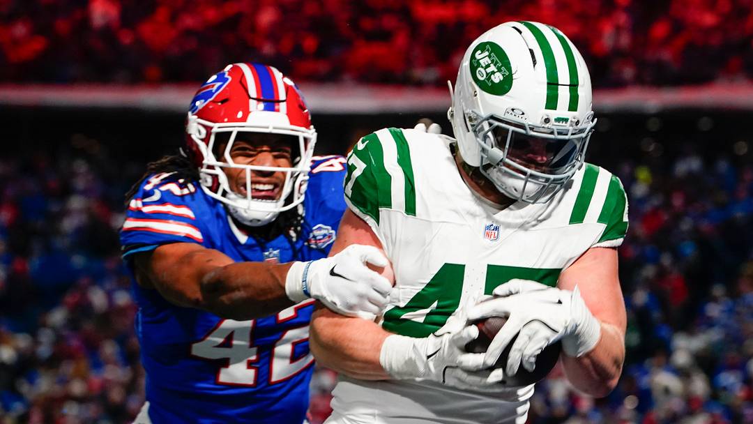 Jan 4, 2026; Orchard Park, New York, USA; New York Jets fullback Andrew Beck (47) carries the ball for a touchdown defended by Buffalo Bills linebacker Dorian Williams (42) during the fourth quarter at Highmark Stadium. Mandatory Credit: Gregory Fisher-Imagn Images