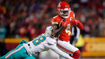 Jan 13, 2024; Kansas City, Missouri, USA; Kansas City Chiefs wide receiver Rashee Rice (4) moves the ball ahead of Miami Dolphins cornerback Ethan Bonner (38) during the first half of the 2024 AFC wild card game at GEHA Field at Arrowhead Stadium. Mandatory Credit: Jay Biggerstaff-USA TODAY Sports
